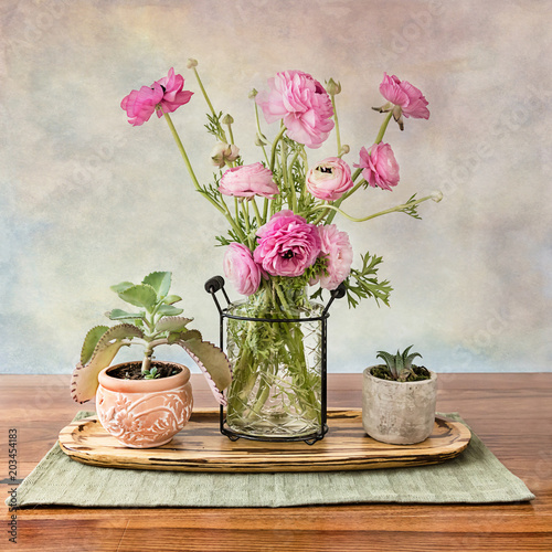 Ranunculus bouquet in wire glass vase centerpiece