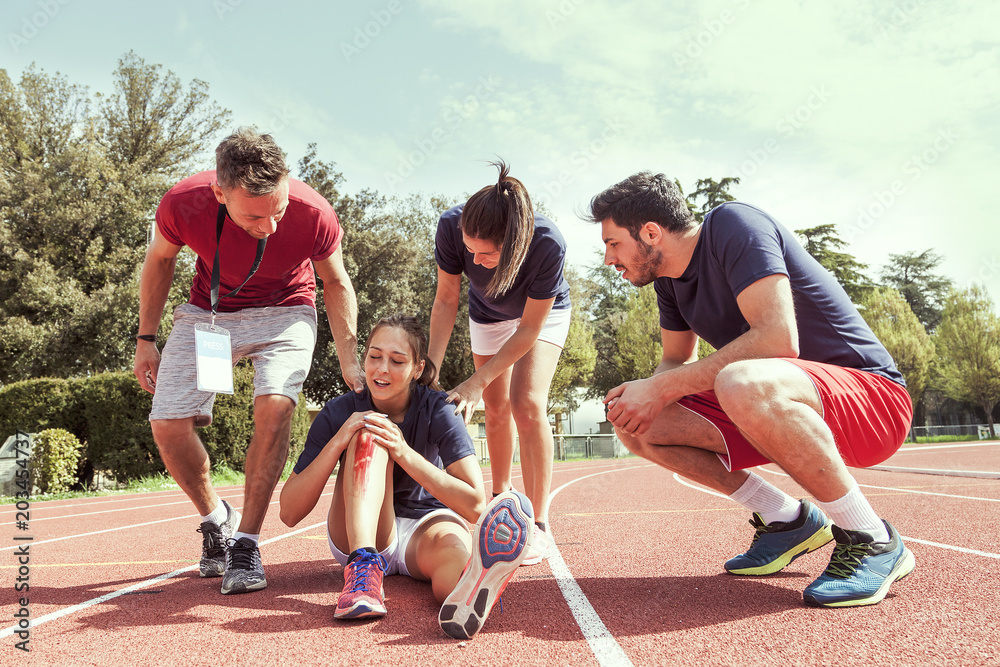 Obraz premium young athlete injured to knee on the track