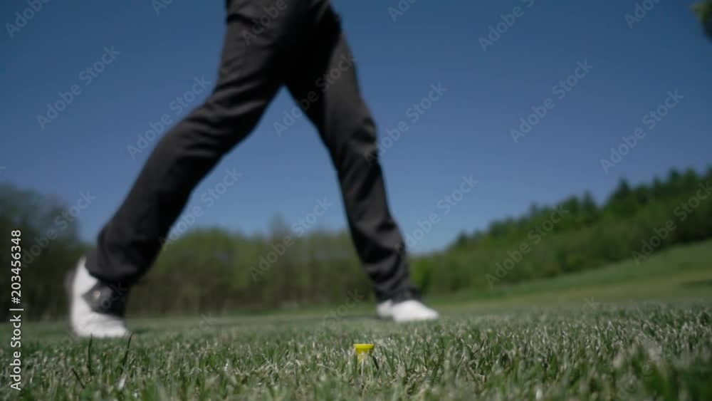 golf club hitting ball on the green artificial grass in slow motion golf club hitting ball on the green artificial grass in slow motion
