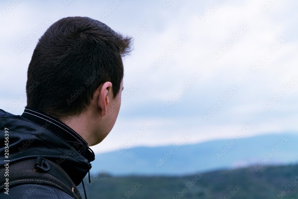 The guy looks into the distance, looks at the landscape, a man thinks The guy looks into the distance, looks at the landscape, a man thinks