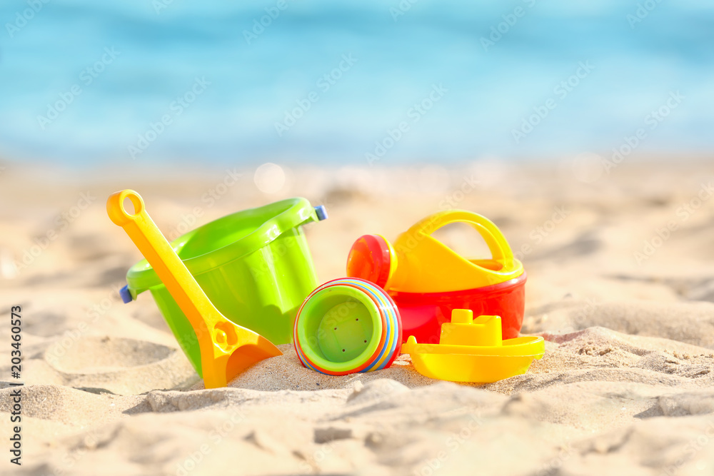 Colorful plastic sand toys on beach Colorful plastic sand toys on beach