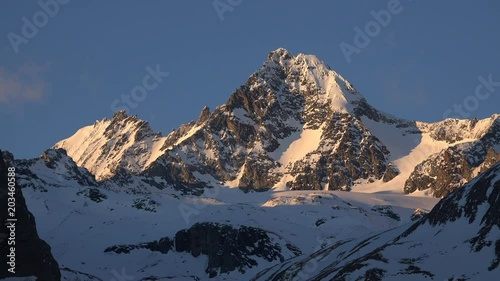 Telephoto time lapse shot of Austria's highest mountain, the Grossglockner as seen from the south with beautiful evening light lighting the main peak.