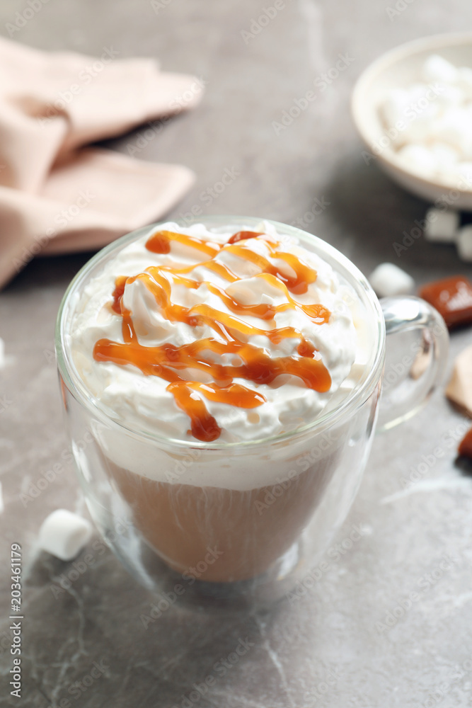 Cup of coffee with caramel topping on grey background Cup of coffee with caramel topping on grey background