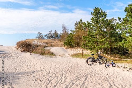 Fototapeta Naklejka Na Ścianę i Meble -  Bikes parked near entrance to beautiful sandy beach. Baltic Sea, Poland.