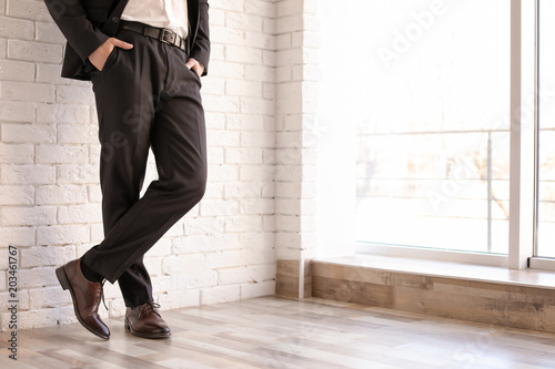 Man in elegant suit and leather shoes indoors, closeup