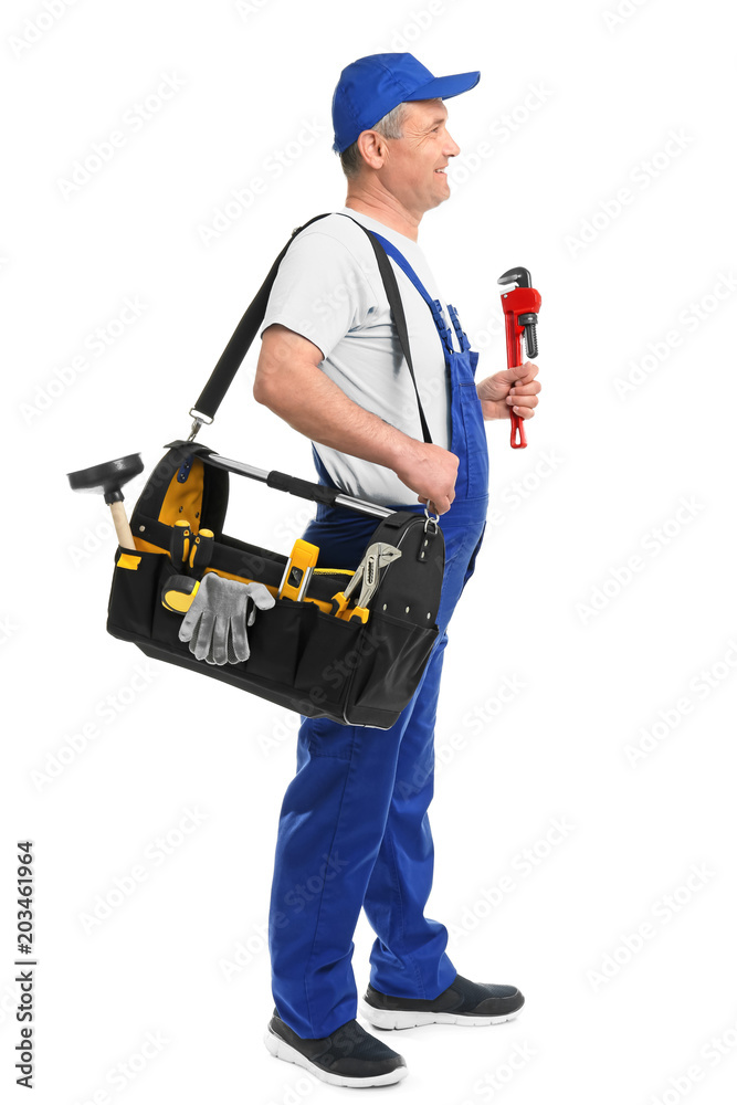Mature plumber with pipe wrench and tool bag on white background
