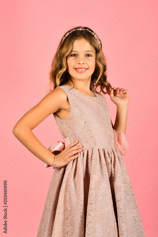 Beautiful little girl model wearing a pink dress