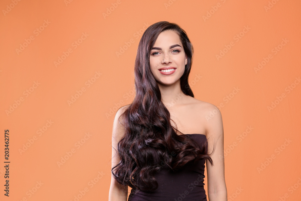 Portrait of beautiful model with gorgeous curly hair on color background Portrait of beautiful model with gorgeous curly hair on color background