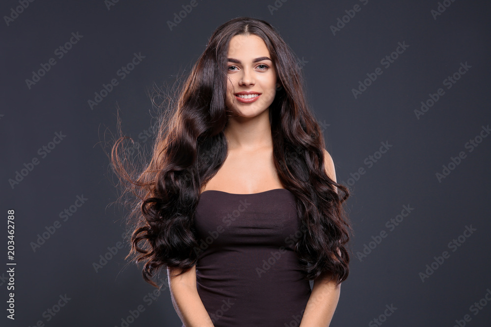 Portrait of beautiful model with gorgeous curly hair on black background Portrait of beautiful model with gorgeous curly hair on black background