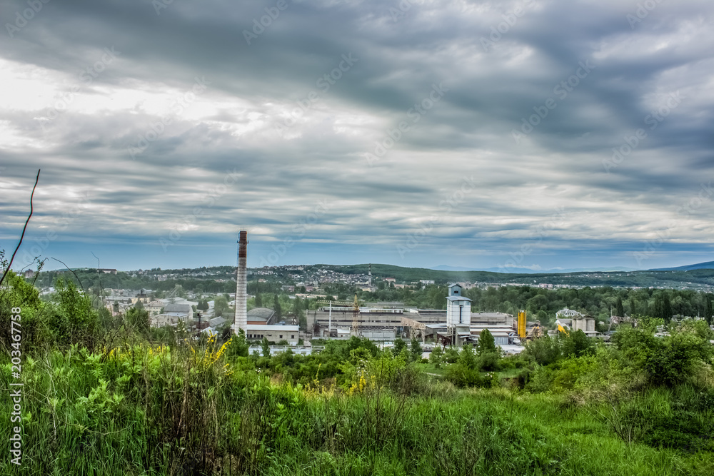 Soft focus pollution factory in forest green valley
