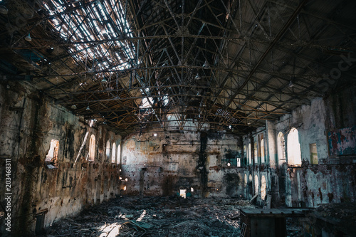 Disaster concept, inside old ruined abandoned industrial factory building, large creepy hall interior