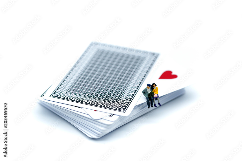 Miniature people : Couple of love sitting on playing card,Lover concept. Miniature people : Couple of love sitting on playing card,Lover concept.