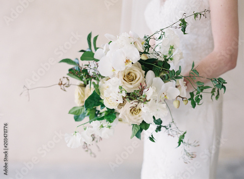 Midsection of bride holding bouquet