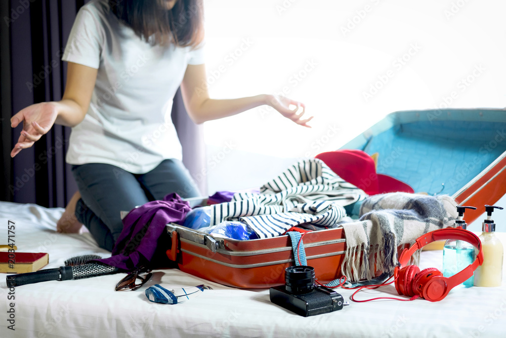 Young Woman Packing Her Clothes Travelling Bedroom Stock Photo by