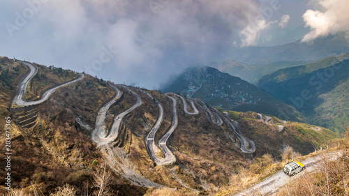 Three Level Zigzag road is probably the most dizzying road in the world. Located in the Sikkim Indian state, in the Himalayan mountains, the road includes more than 100 hairpins in just 30km. photo