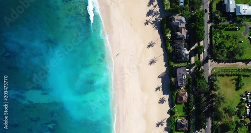 Aerial top down view of white sand beach and blue ocean waves in Hawaii