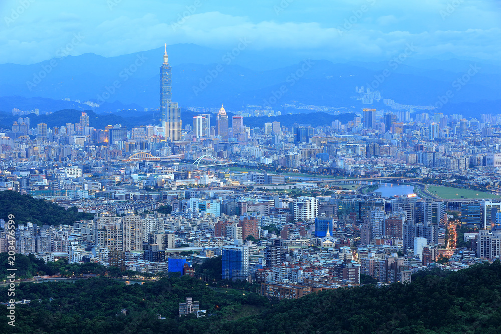 Aerial panorama of Taipei downtown & suburbs at dusk with view of Keelung Riverside Park, MacArthur bridge, Taipei 101 in Xinyi District ~ A romantic night in busy Taipei City in a gloomy blue mood