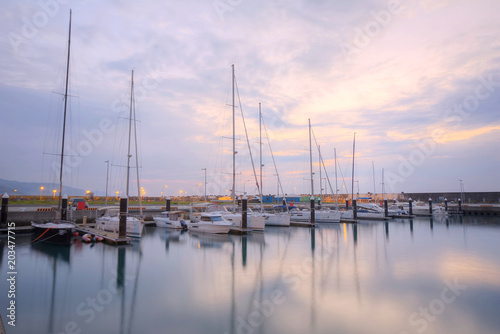 Beautiful scenery of fishing boats and yachts parking in marina under stormy sky in I-lan, Taiwan ~ Dramatic moody sky at sunrise by the beach before an oncoming storm  © AaronPlayStation