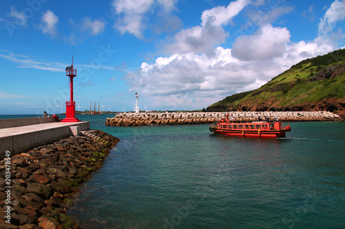 Beautiful harbor and cruise ship of Chagwido, Jeju in Korea. The sea is soothing cool and emerald green. photo