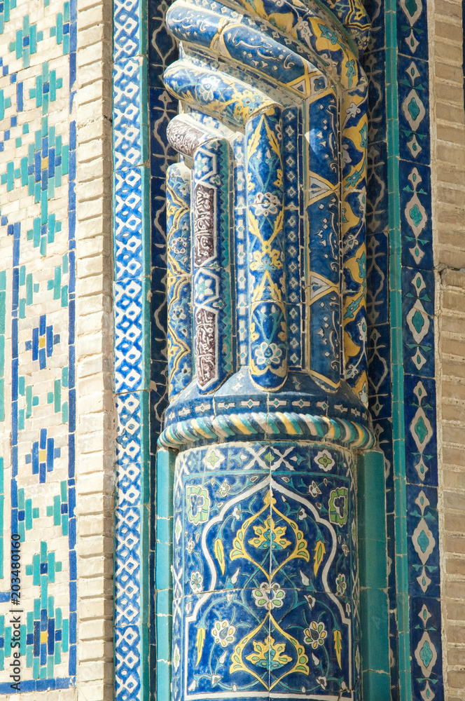 Fragment of a column in the wall with the mosaic. the details of the architecture of medieval Central Asia