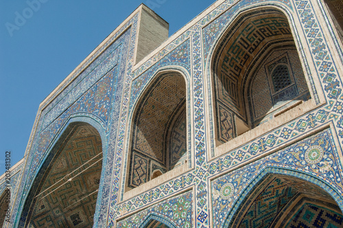 The arch and the exterior design of the ancient Registan in Samarkand. Ancient architecture of Central Asia