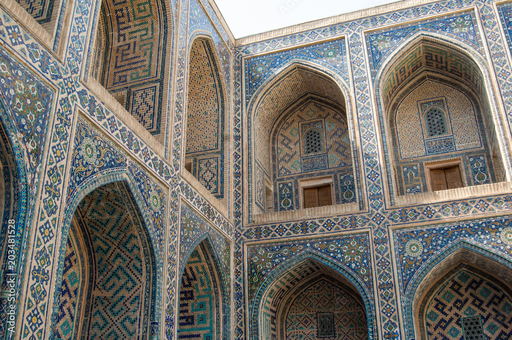 The arch and the exterior design of the ancient Registan in Samarkand. Ancient architecture of Central Asia