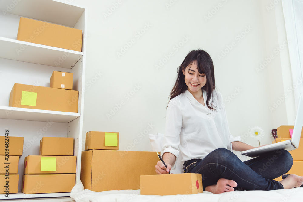 Beauty Asian woman using laptop and start up small business entrepreneur SME and checking order list in bedroom, Young happy freelance woman shopping online marketing or sending parcel to customers Beauty Asian woman using laptop and start up small business entrepreneur SME and checking order list in bedroom, Young happy freelance woman shopping online marketing or sending parcel to customers