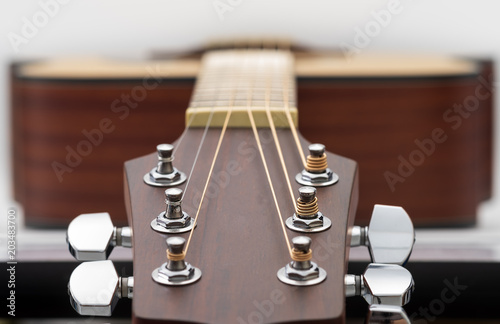 An acoustic guitar headstock on white background.