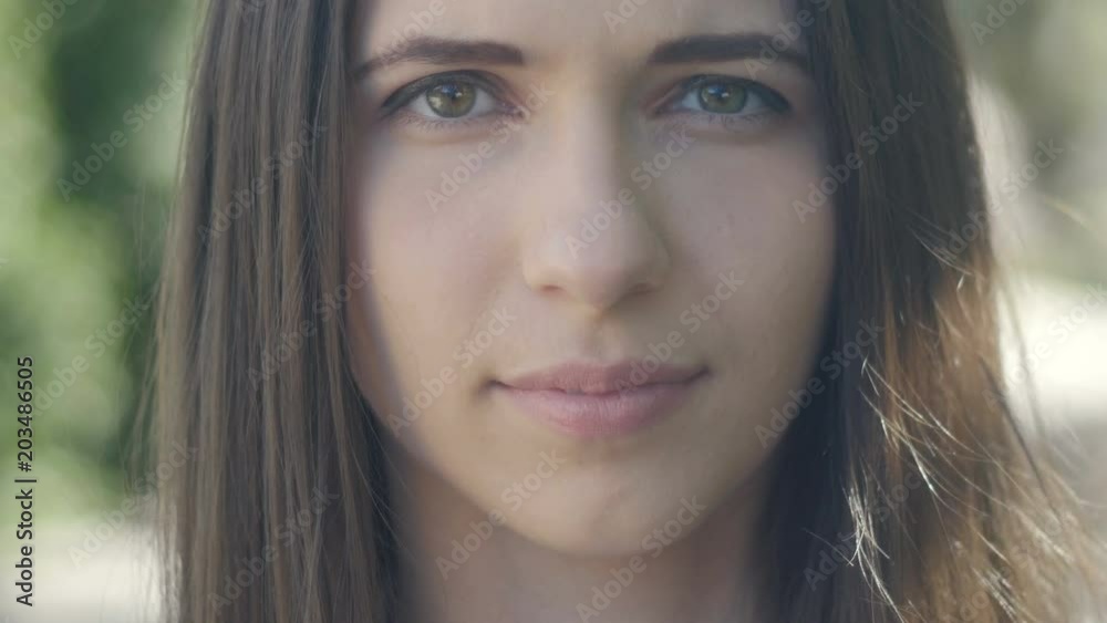 Face portrait of beautiful young woman at city street. Close up Face portrait of beautiful young woman at city street. Close up