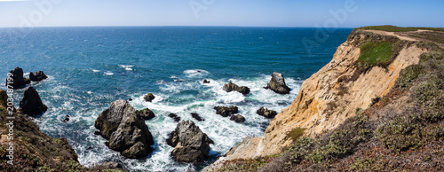 Panorama of beach and dramatic cliffs at Bodega Head Trail, Bodega Bay, California United States on sunny summer day