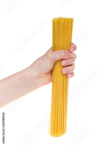 Young female hand holding dry spaghetti pasta isolated on white background.