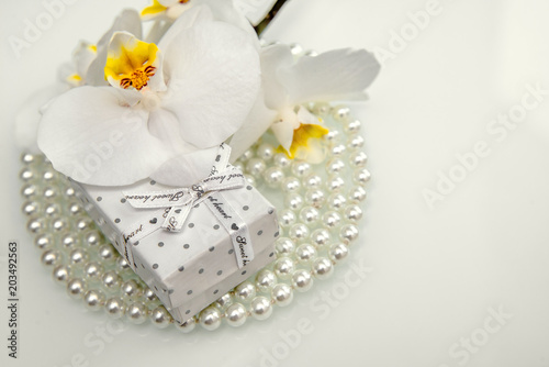 Gift box and white orchid on a white background 