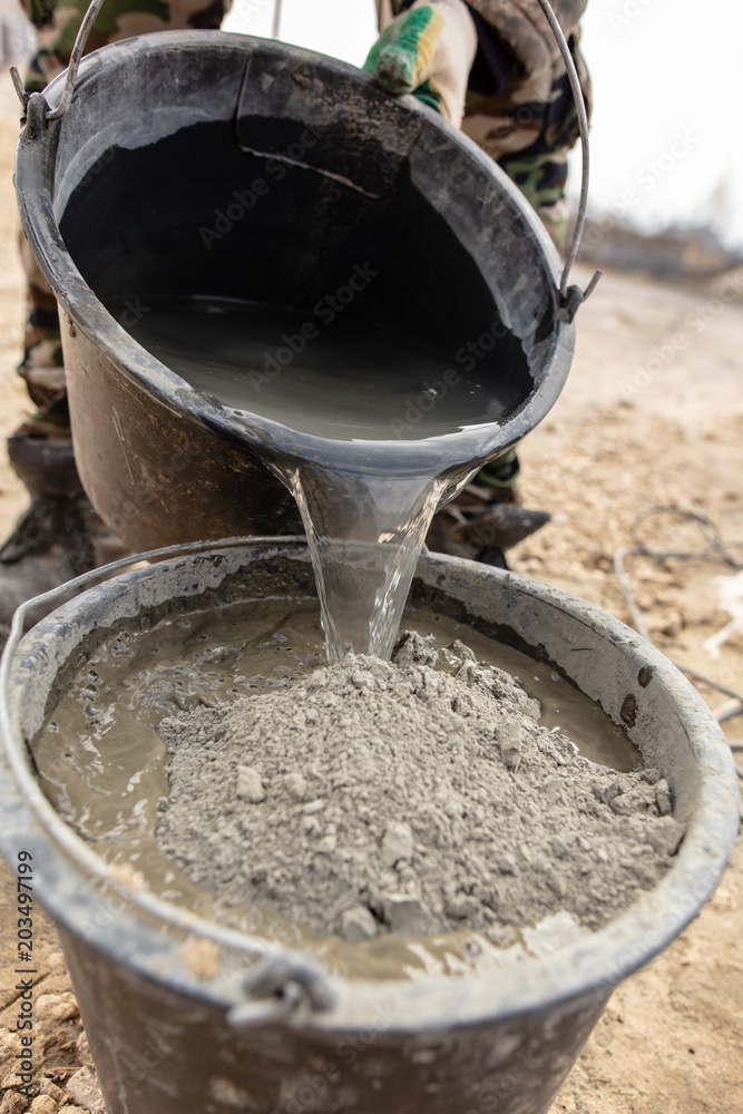 mixture of concrete in a bucket at a construction site mixture of concrete in a bucket at a construction site