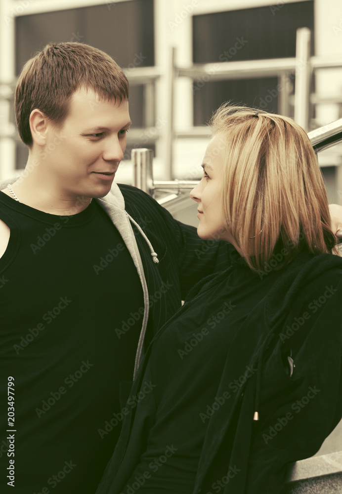 Happy young couple flirting in city street Happy young couple flirting in city street