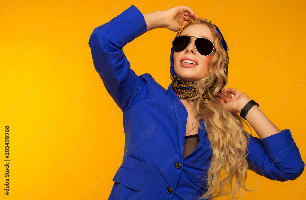 fashion portrait of a beautiful blonde in a blue scarf and jacket in sunglasses fashion portrait of a beautiful blonde in a blue scarf and jacket in sunglasses