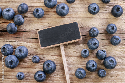 Blank blackboard label, blueberries around