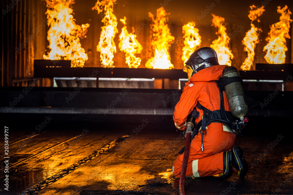 Firefighters training, Team practice to fighting with fire in emergency situation..Spray water to the flame Firefighters training, Team practice to fighting with fire in emergency situation..Spray water to the flame