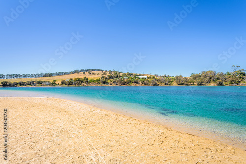 Fototapeta Naklejka Na Ścianę i Meble -  Cremorne Beach, South-Arm Peninsula, Tasmania, Australia: Relaxing quiet fishing day at a sandy beach river ocean coastline perfect sunny summer weather and blue water green mountains in background