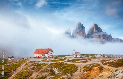 Great foggy view of the National park Tre Cime di Lavaredo. Location Dolomiti alps, Italy,
