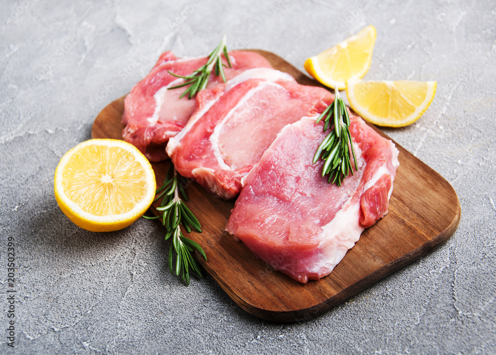 Fresh raw pork chops with spices and herbs Fresh raw pork chops with spices and herbs