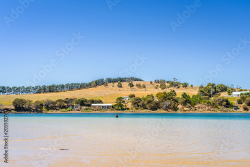 Cremorne Beach, South-Arm Peninsula, Tasmania, Australia: Relaxing quiet fishing day at a sandy beach river ocean coastline perfect sunny summer weather and blue water green mountains in background