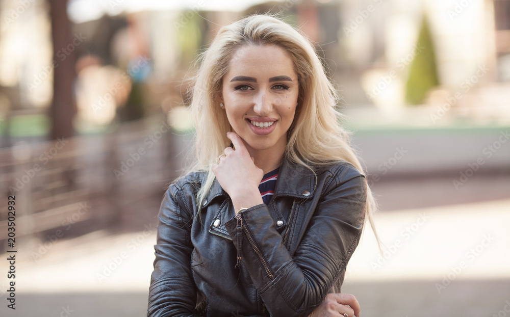 Fototapeta premium Wonderful smiling blonde woman with a lovely look and bright make up. Natural young beauty. Outdoors