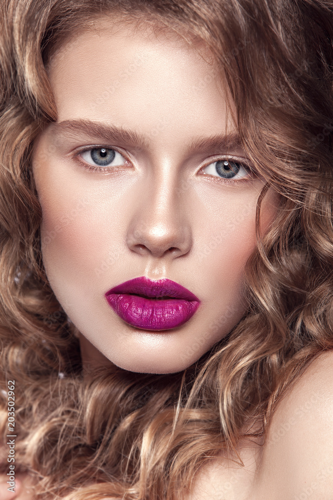 portrait of a beautiful girl with natural make-up. Clean healthy skin, hair and natural lips with bright lipstick. Hairstyle curls. Photographed in studio on a white background. portrait of a beautiful girl with natural make-up. Clean healthy skin, hair and natural lips with bright lipstick. Hairstyle curls. Photographed in studio on a white background.