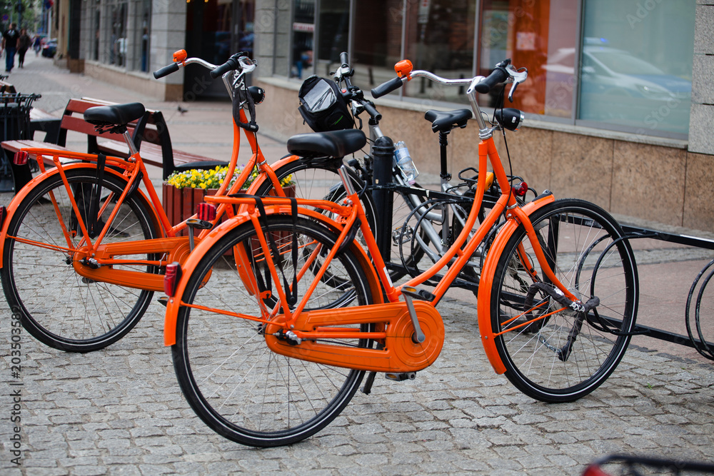 Two orange bikes in Wroclaw