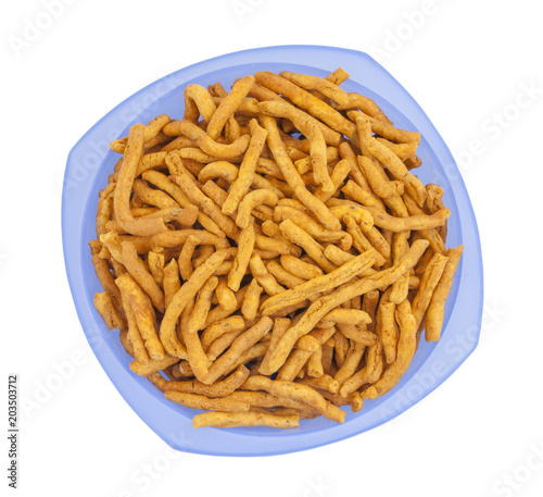 Sev is a popular Indian snack food consisting of small pieces of crunchy noodles made from chickpea flour paste, which are seasoned with turmeric, cayenne, and ajwain before being deep-fried in oil.
