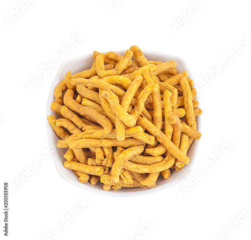 Sev is a popular Indian snack food consisting of small pieces of crunchy noodles made from chickpea flour paste, which are seasoned with turmeric, cayenne, and ajwain before being deep-fried in oil.