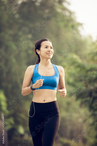 young sports woman runner running on road