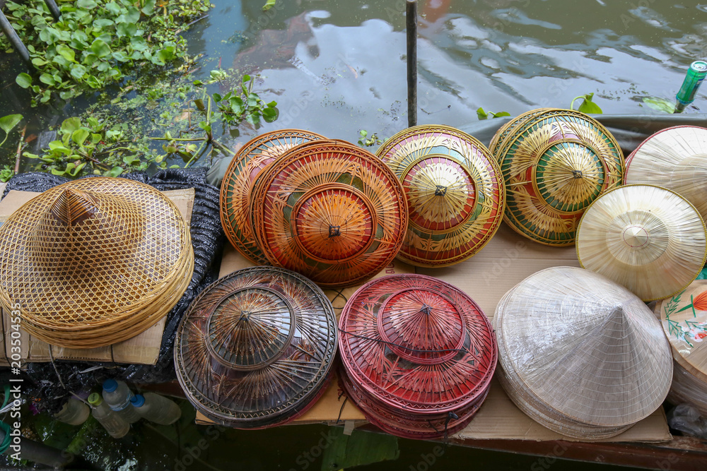 souvenir shop on boat at floating market in Thailand, Asia which sale headgear and hat by handmade