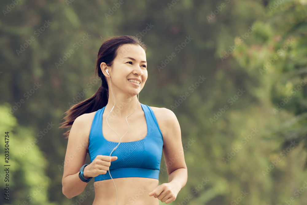 young sports woman runner running on road young sports woman runner running on road