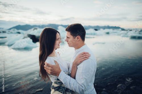 Happy stylish smiling couple walking and kissing in Iceland , on